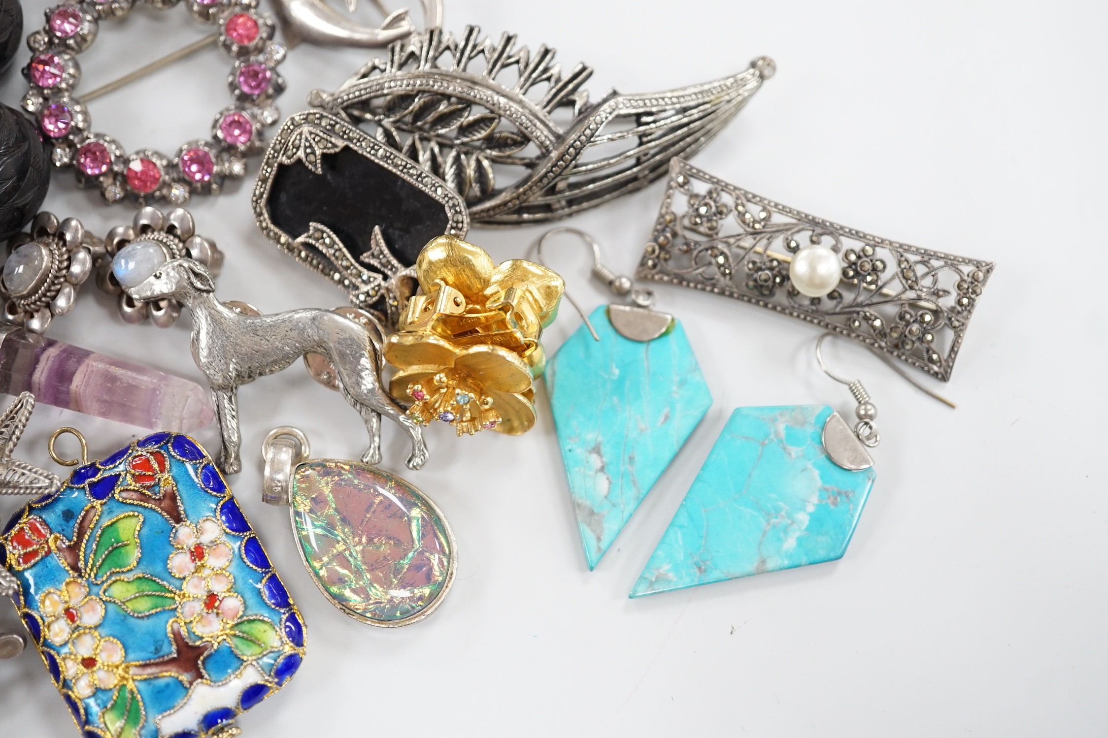 A silver charm bracelet hung with fifty assorted charms and a group of assorted jewellery including enamelled locket, Victorian agate fob seal carved with a bird, scarab pendant, coloured paste set brooch, 925 triple dol